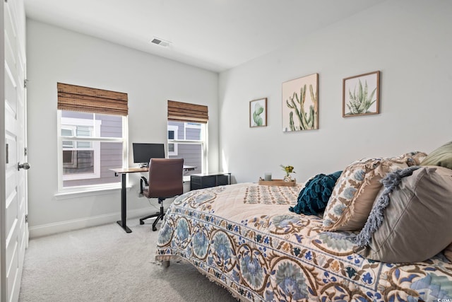 bedroom featuring light carpet