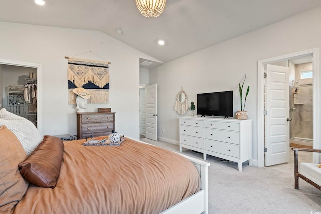 bedroom with light carpet, lofted ceiling, and a walk in closet