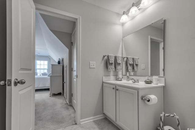 bathroom with ensuite bath, baseboards, and vanity