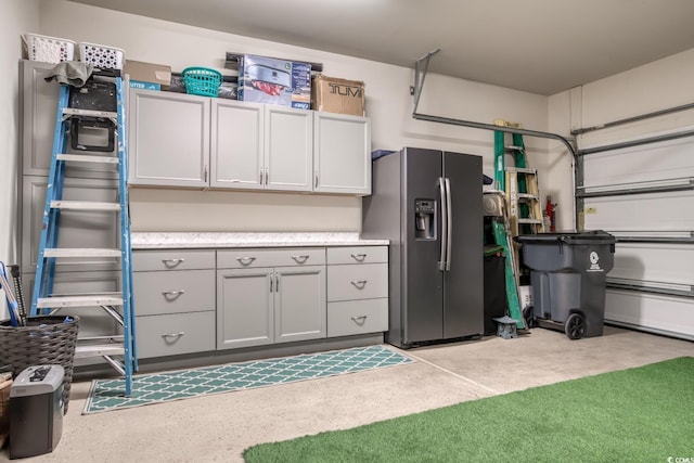 garage with stainless steel fridge with ice dispenser