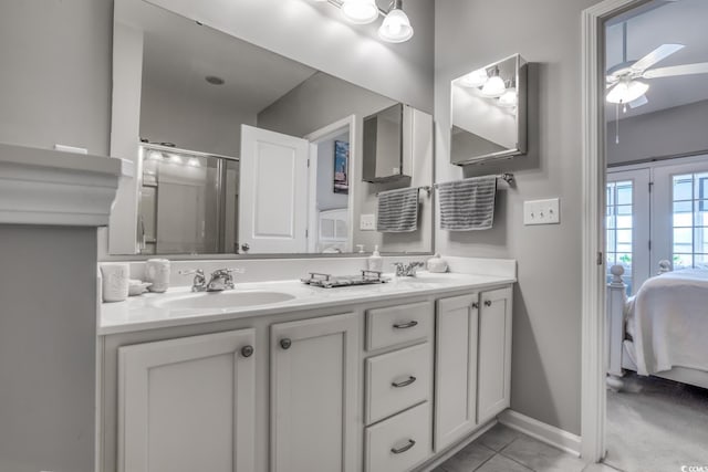 ensuite bathroom with ensuite bath, ceiling fan, a shower with shower door, tile patterned flooring, and a sink