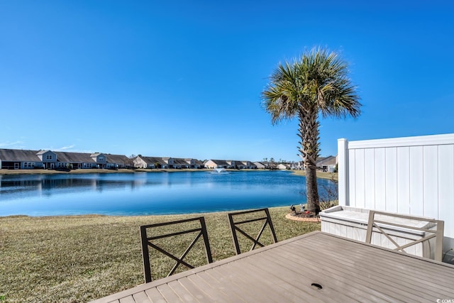 exterior space featuring a yard, a water view, and a residential view