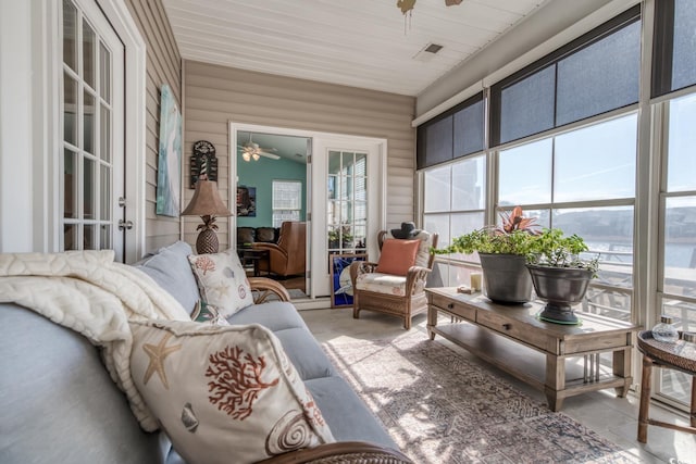 sunroom / solarium featuring ceiling fan, visible vents, and a wealth of natural light