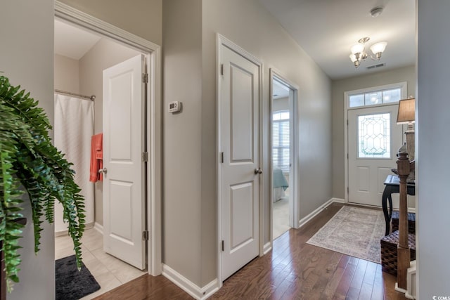 entrance foyer with light wood-type flooring, visible vents, and baseboards