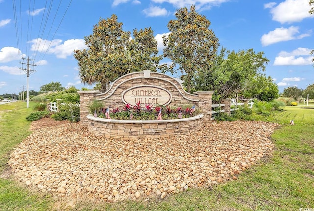 community / neighborhood sign featuring a yard