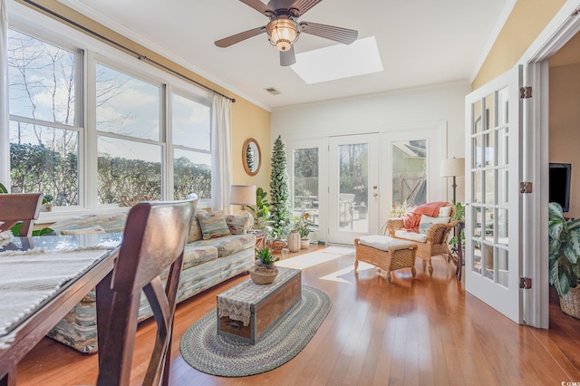 17 Racquet Club Dr, Pawleys Island, SC 29585 - living room featuring french doors, a ceiling fan, a skylight, hardwood / wood-style floors, and ornamental molding