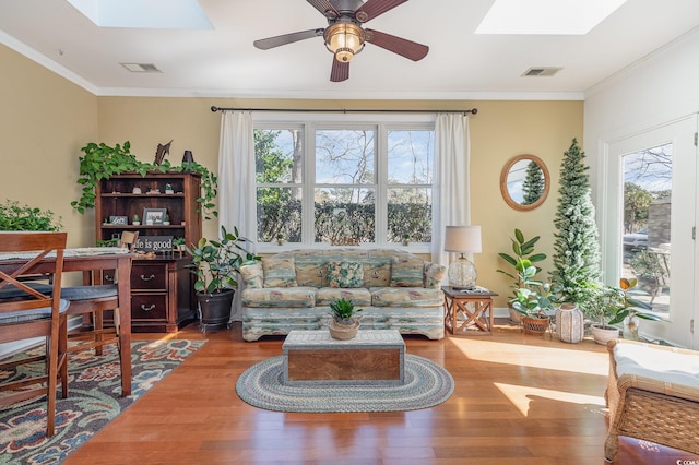 17 Racquet Club Dr, Pawleys Island, SC 29585 - living area with a skylight, wood finished floors, a ceiling fan, and crown molding