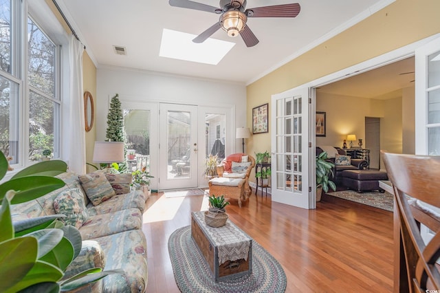 17 Racquet Club Dr, Pawleys Island, SC 29585 - living area with french doors, healthy amount of natural light, ornamental molding, wood finished floors, and a skylight