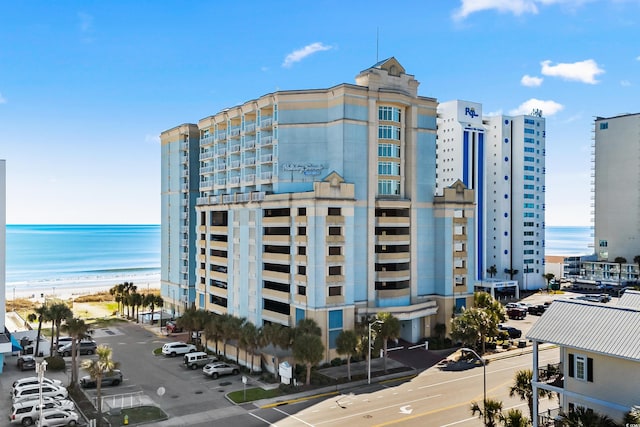 view of property featuring a water view and a view of the beach