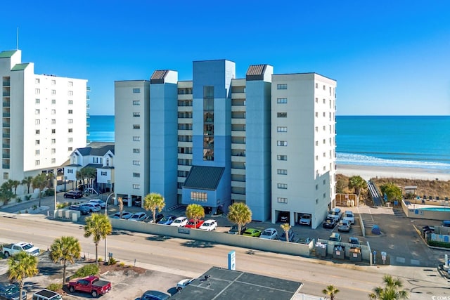 view of property with a beach view and a water view