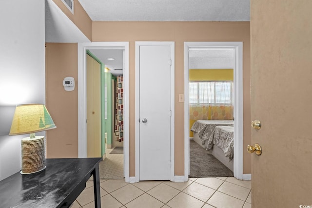 hall featuring light tile patterned flooring