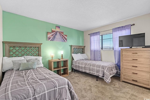 bedroom featuring a textured ceiling and light carpet