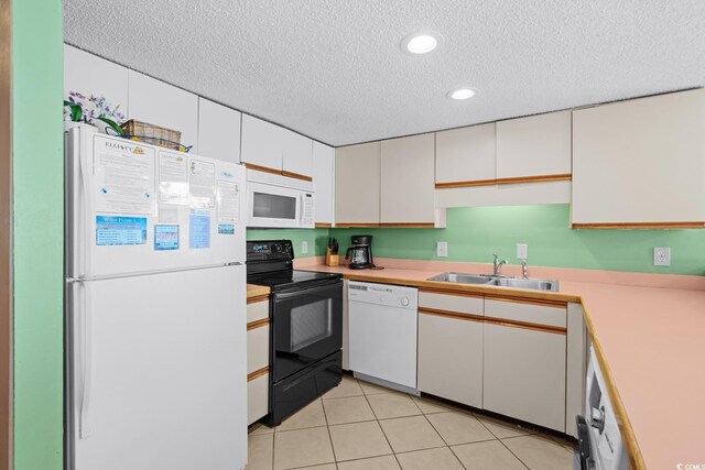 kitchen with sink, white appliances, white cabinetry, and a textured ceiling