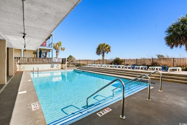 view of swimming pool with a patio