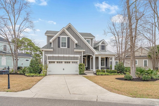 craftsman inspired home featuring a garage and a front yard