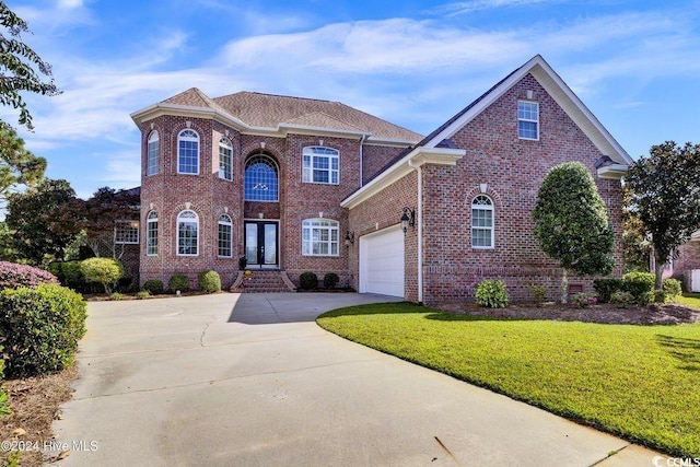 view of front property featuring a garage and a front lawn