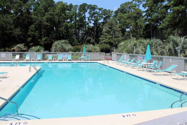 219 Salt Marsh Cir Unit 14A, Pawleys Island, SC 29585 - community pool featuring a patio area and view of scattered trees