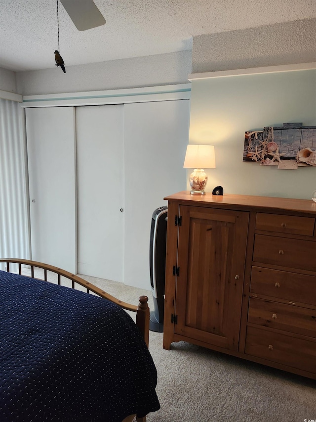 219 Salt Marsh Cir Unit 14A, Pawleys Island, SC 29585 - bedroom featuring light colored carpet, a textured ceiling, a closet, and a ceiling fan