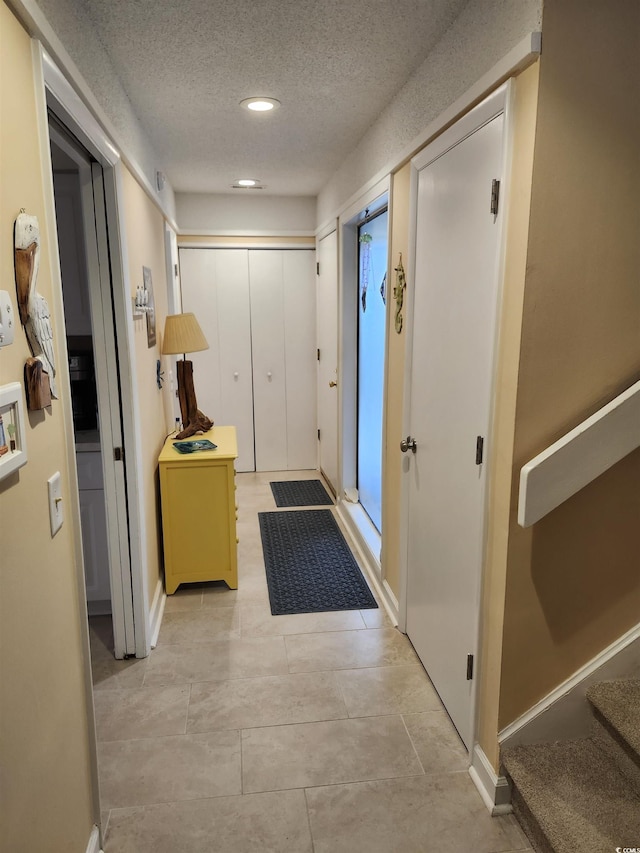 219 Salt Marsh Cir Unit 14A, Pawleys Island, SC 29585 - corridor with a textured ceiling, recessed lighting, and light tile patterned flooring
