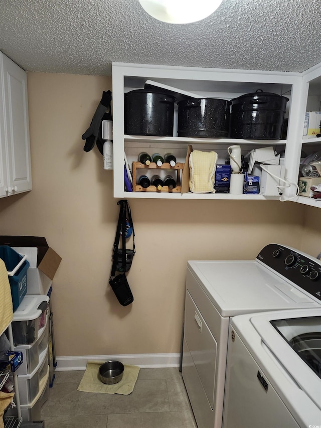 219 Salt Marsh Cir Unit 14A, Pawleys Island, SC 29585 - washroom featuring washing machine and clothes dryer, a textured ceiling, cabinet space, and tile patterned floors
