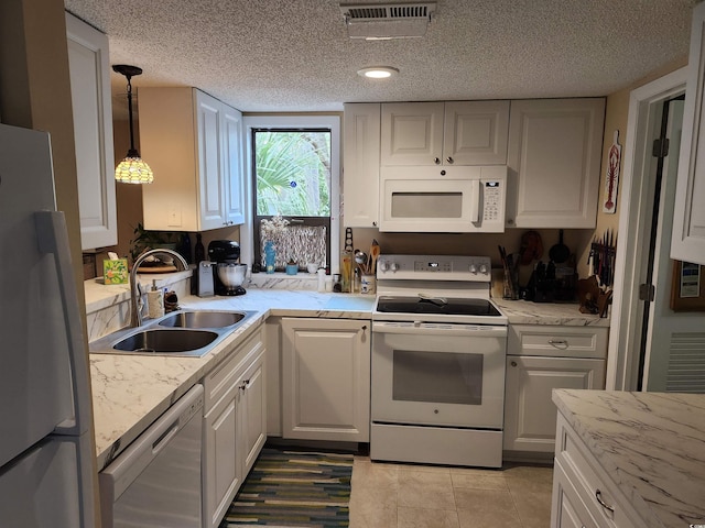 219 Salt Marsh Cir Unit 14A, Pawleys Island, SC 29585 - kitchen featuring white appliances, white cabinetry, a textured ceiling, decorative light fixtures, and light tile patterned floors