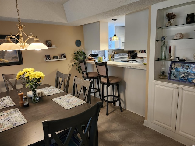 219 Salt Marsh Cir Unit 14A, Pawleys Island, SC 29585 - dining room featuring a chandelier and dark tile patterned flooring