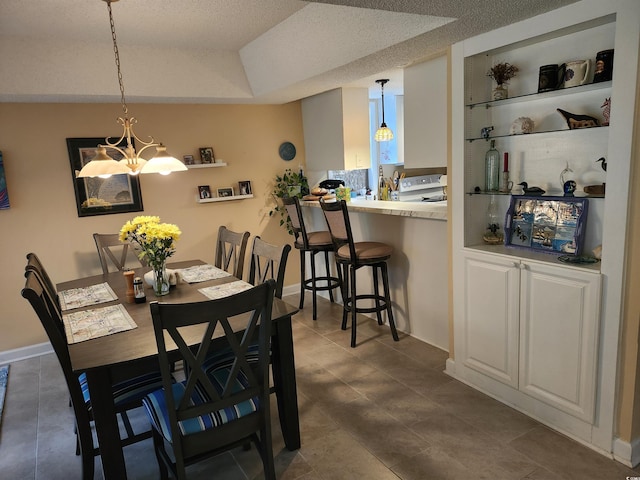 219 Salt Marsh Cir Unit 14A, Pawleys Island, SC 29585 - dining room featuring a chandelier and dark tile patterned floors
