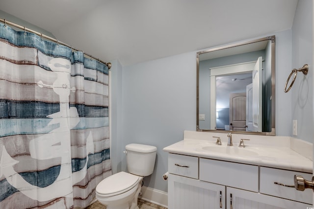 bathroom featuring toilet, a shower with shower curtain, and vanity