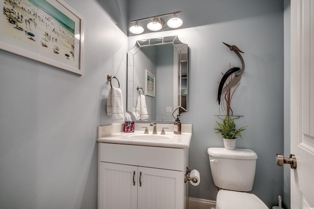 bathroom featuring toilet and vanity