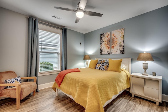 bedroom with hardwood / wood-style floors and ceiling fan
