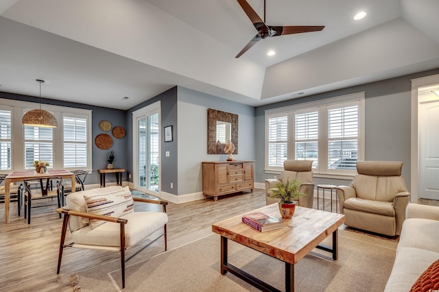 living room with light wood-type flooring, vaulted ceiling, and ceiling fan