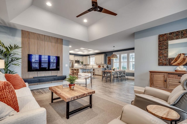 living room with ceiling fan and light wood-type flooring