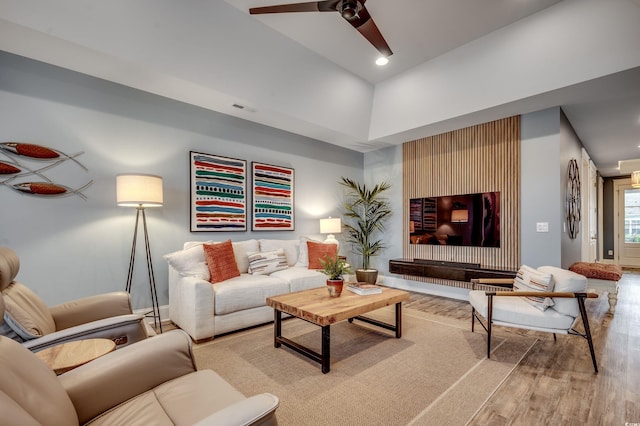 living room with light hardwood / wood-style flooring and ceiling fan