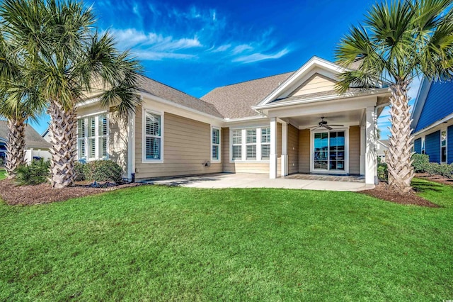 rear view of property featuring a patio area, a lawn, and ceiling fan