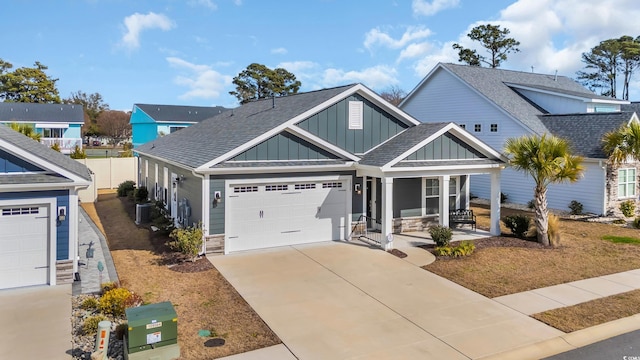 craftsman-style home featuring central air condition unit, covered porch, and a garage