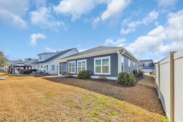 view of front of house featuring a front yard and a gazebo