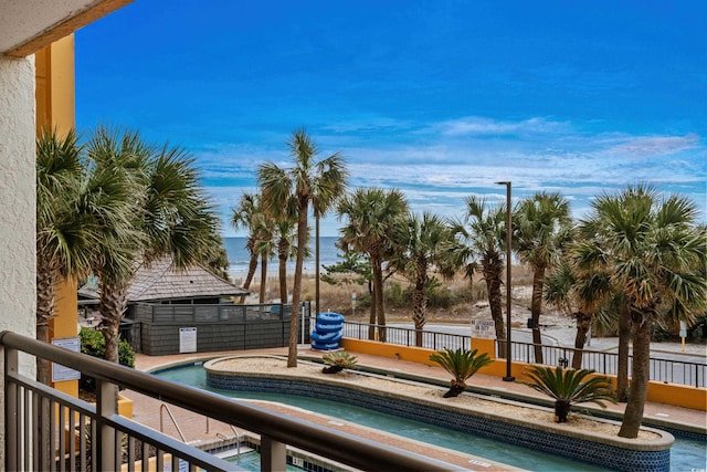 exterior space with a water view and a hot tub