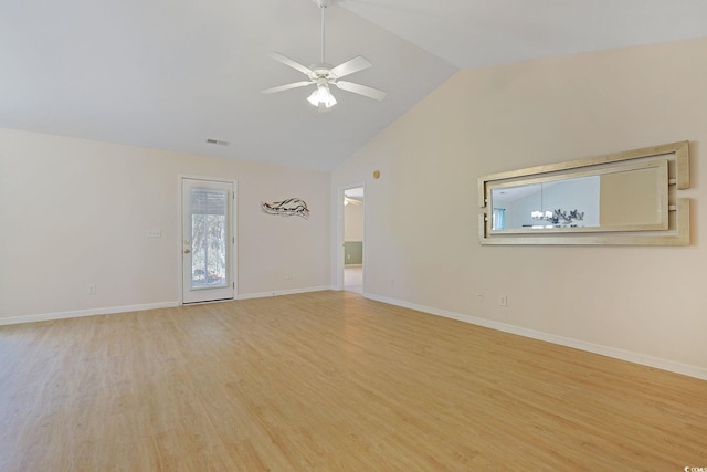 spare room featuring light wood-type flooring, vaulted ceiling, and ceiling fan