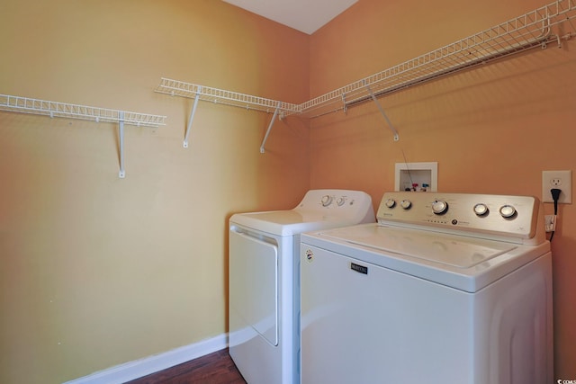 washroom featuring dark wood-type flooring and washing machine and clothes dryer