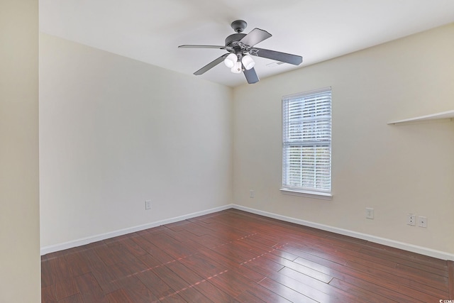 spare room featuring dark hardwood / wood-style flooring and ceiling fan