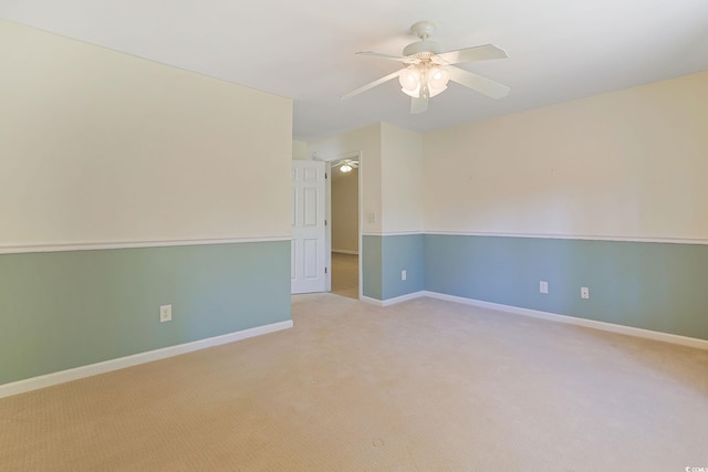 empty room with ceiling fan and light colored carpet