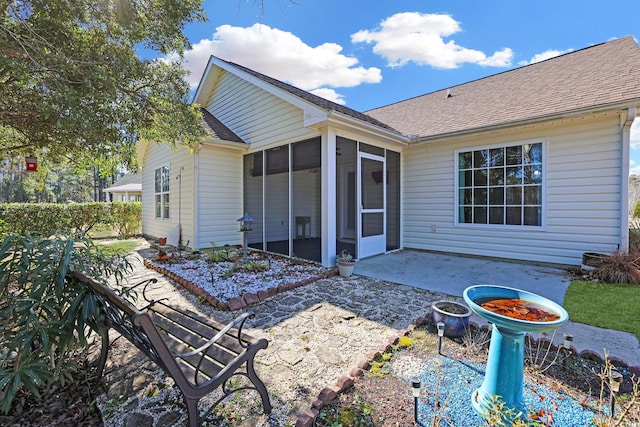 back of property with a patio and a sunroom