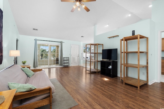 living room with ceiling fan, lofted ceiling, and dark wood-type flooring