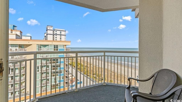 balcony featuring a water view and a beach view