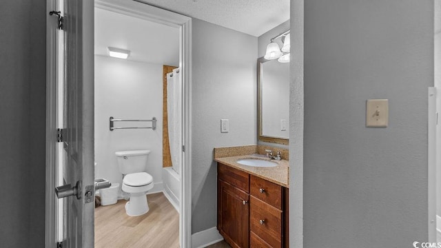 full bathroom with a textured ceiling, toilet, wood finished floors, vanity, and shower / tub combo with curtain