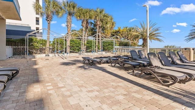 view of patio / terrace with playground community and fence