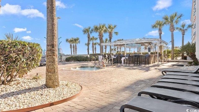 surrounding community with a patio area, an outdoor bar, a pool, and a pergola