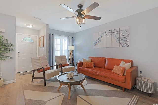 living room with light hardwood / wood-style floors and ceiling fan