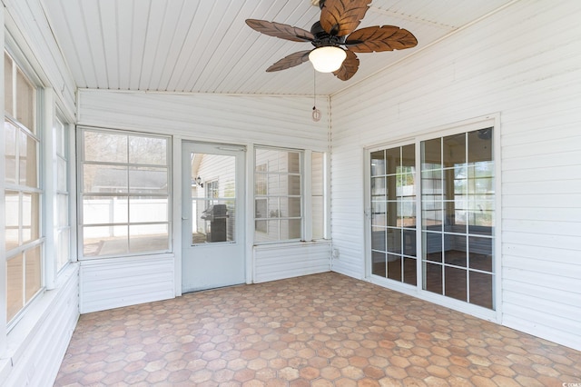 unfurnished sunroom with ceiling fan, vaulted ceiling, and wooden ceiling