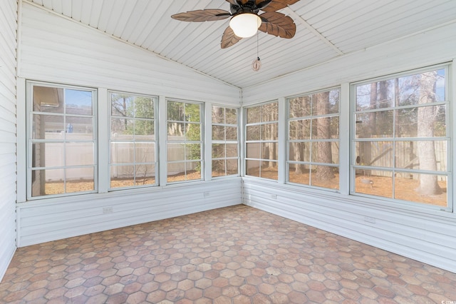 unfurnished sunroom with ceiling fan and vaulted ceiling